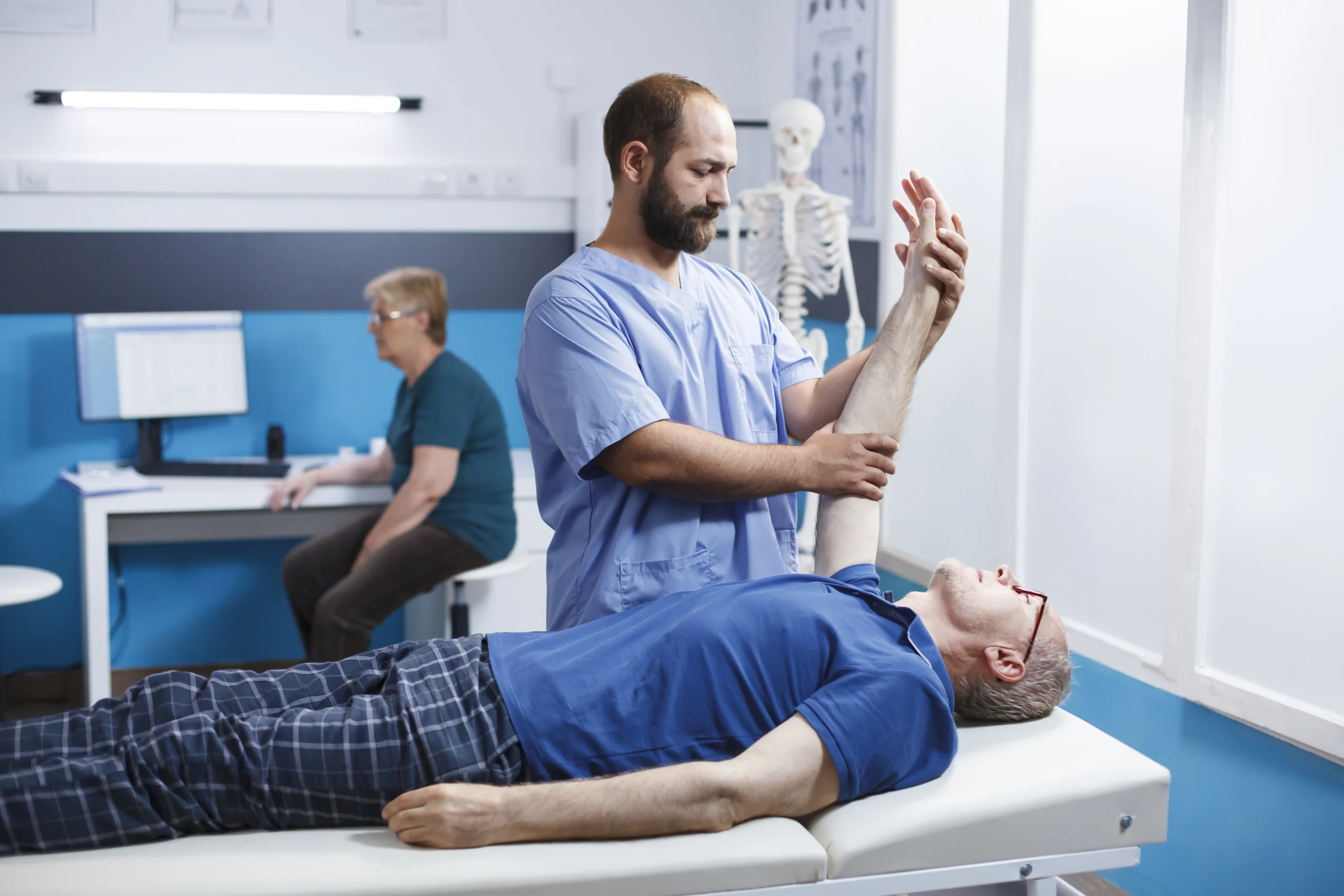 medical nurse helps old man with massage